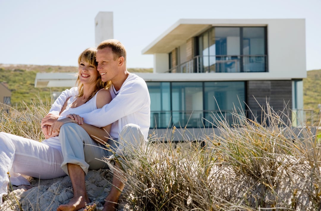 Couple embracing by beach house